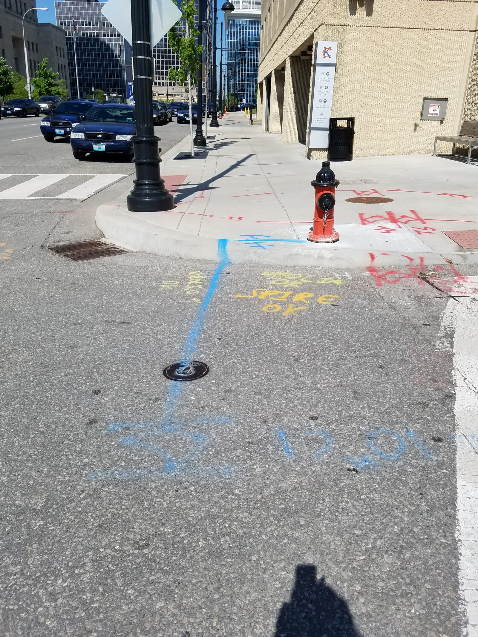 An image of the pavement of an intersection with painted markings showing belowground utilities for construction work.