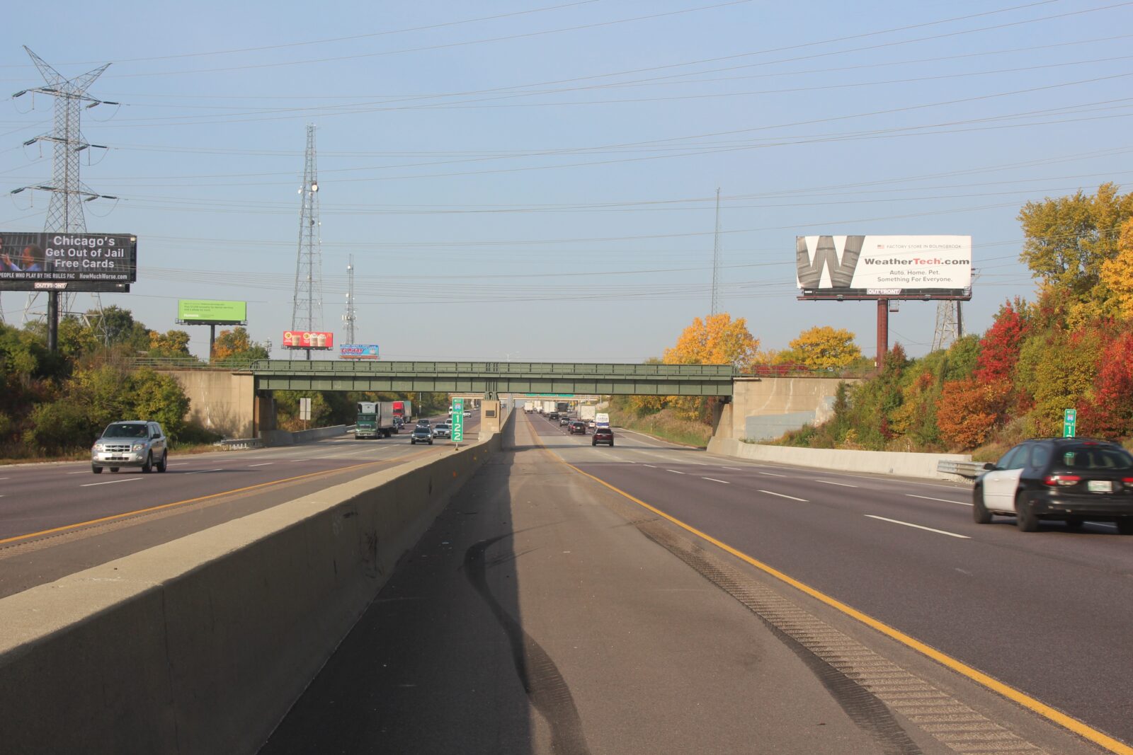 An image of a bridge over a highway. The picture is taken from the inside shoulder of the highway.