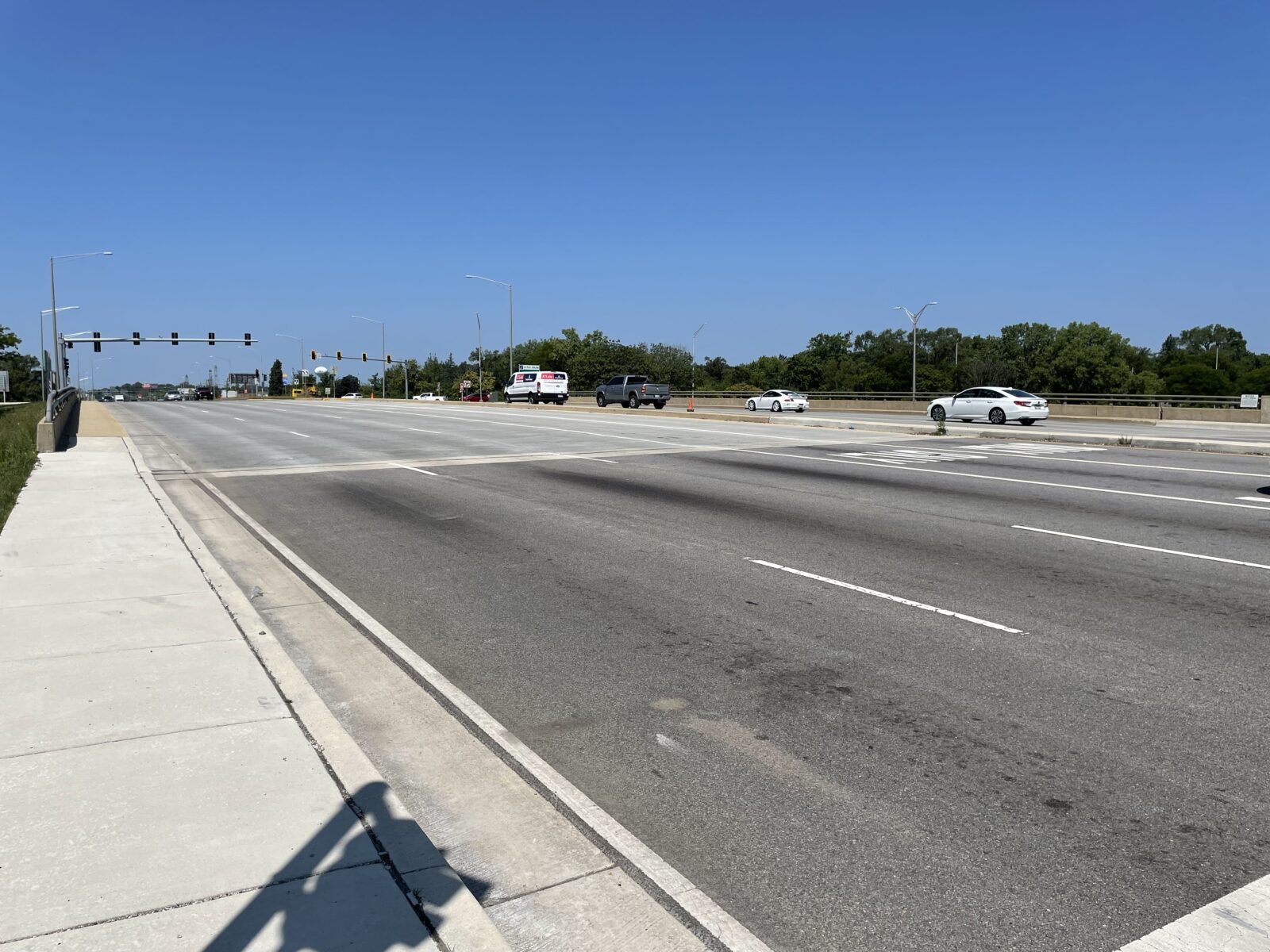 An image of an overpass, taken from the sidewalk next to the road.