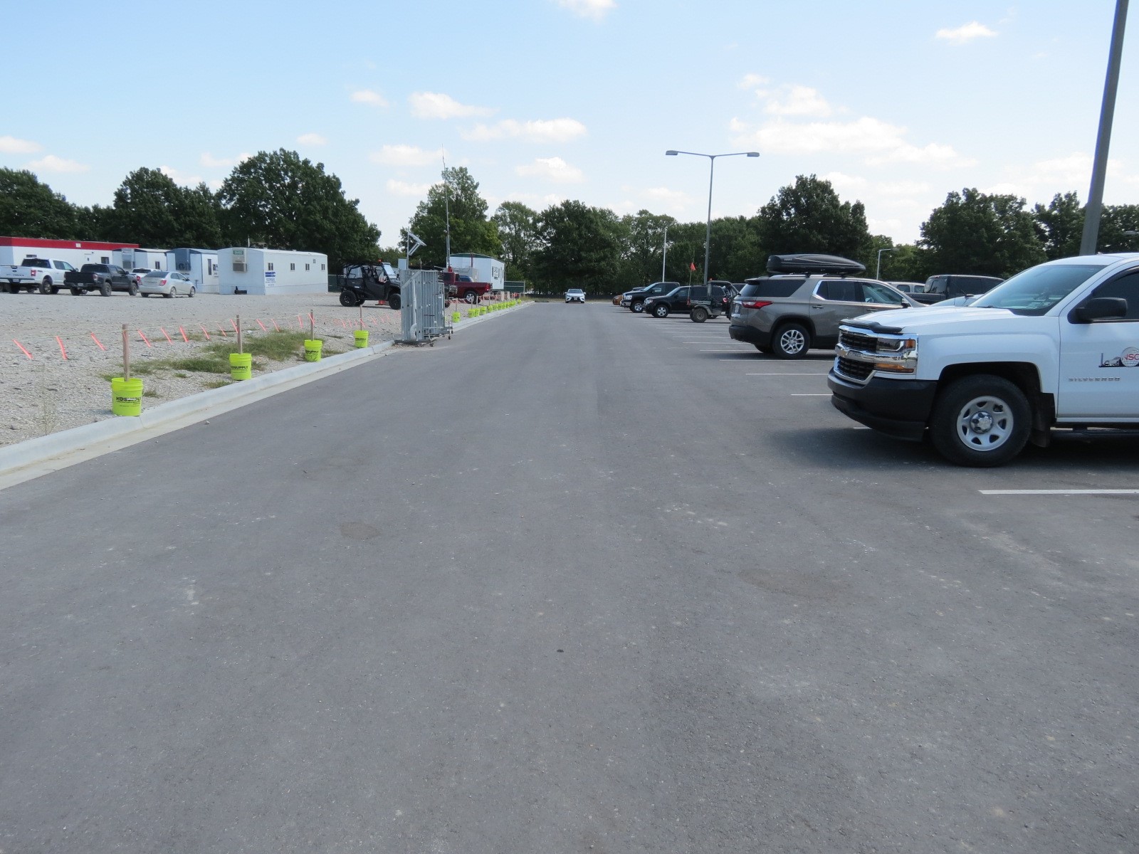 An image of a paved parking lot, with logistics buildings in the background.