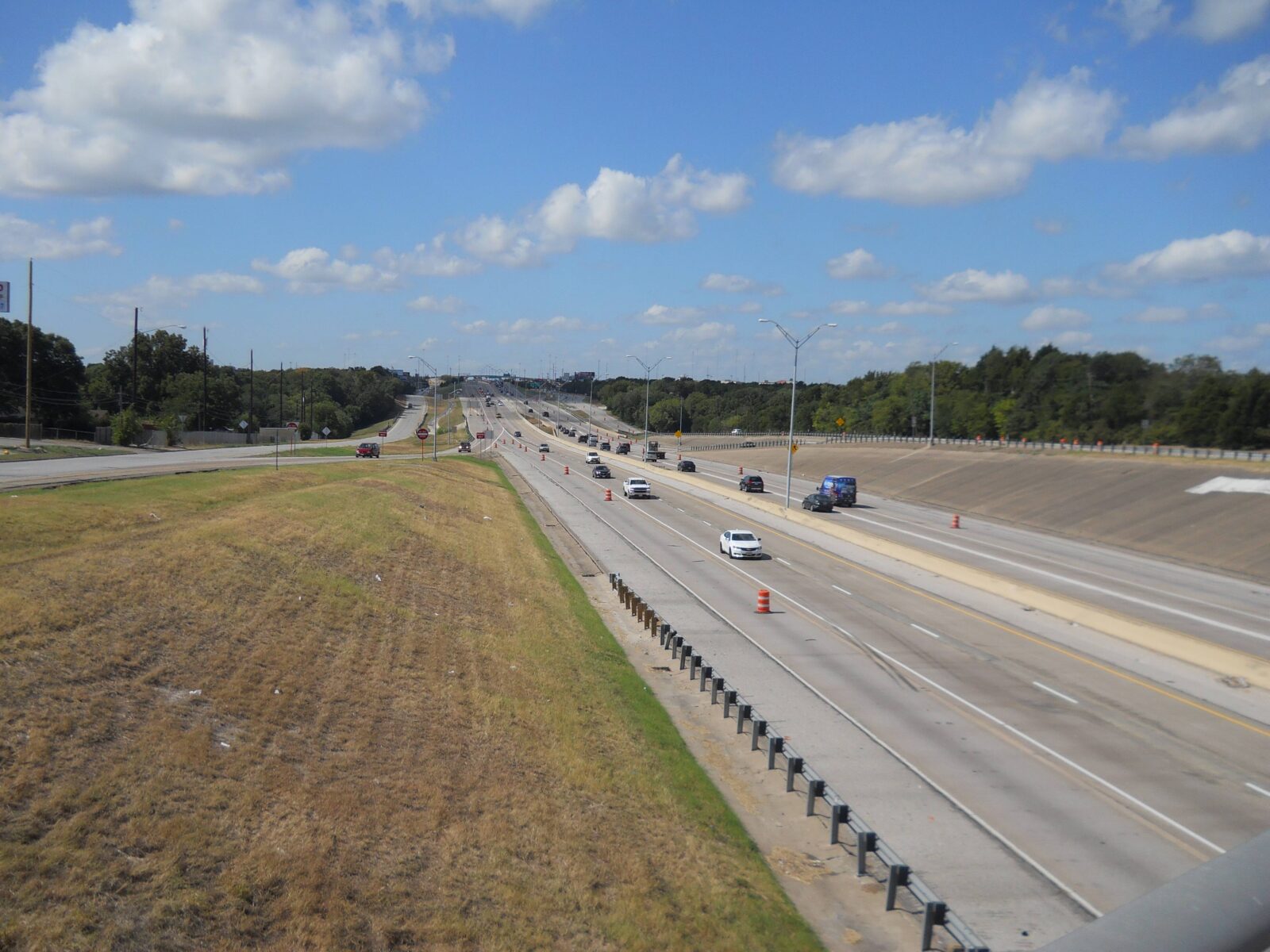 An image of a highway with two lanes of traffic in each direction.
