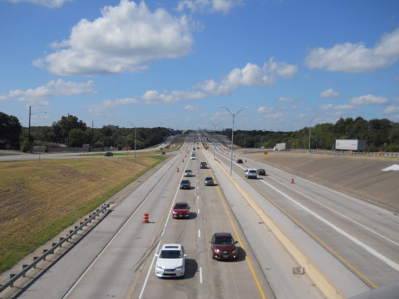 An image of a highway with two lanes of traffic in each direction.