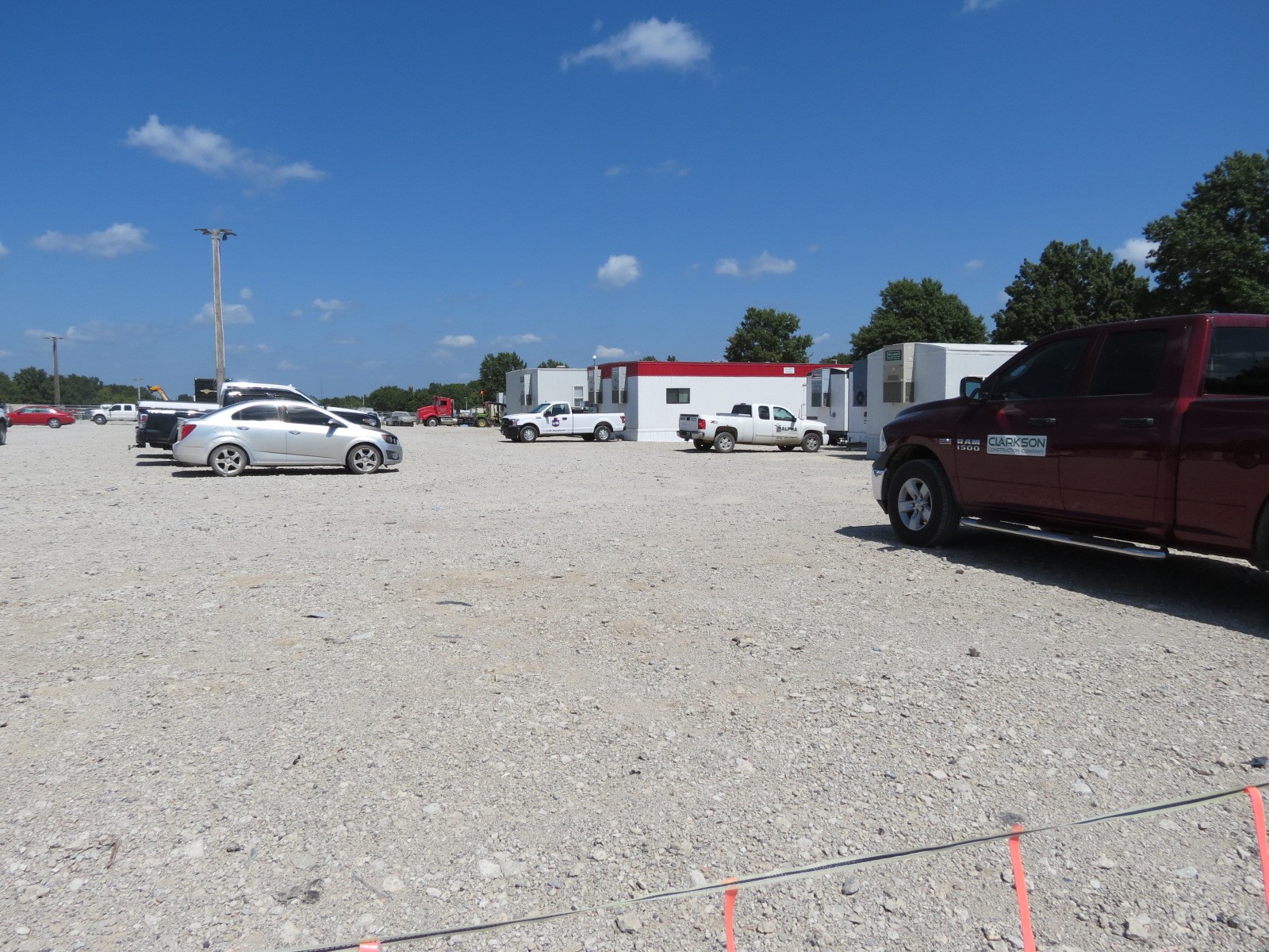 An image of a gravel parking lot with logistics trailers.