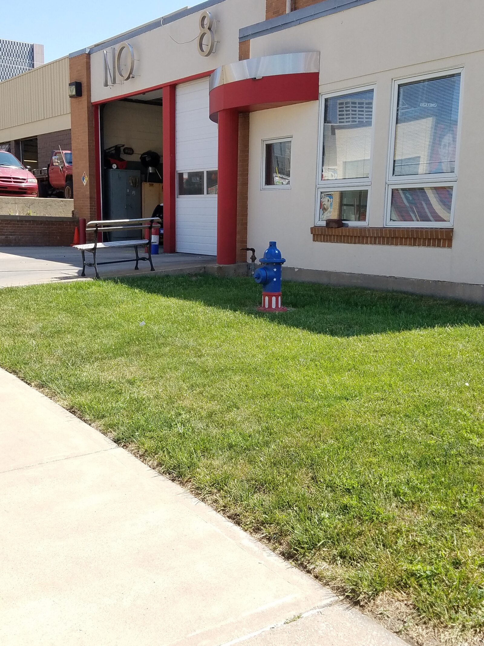 An image of a fire station with a fire hydrant in front.