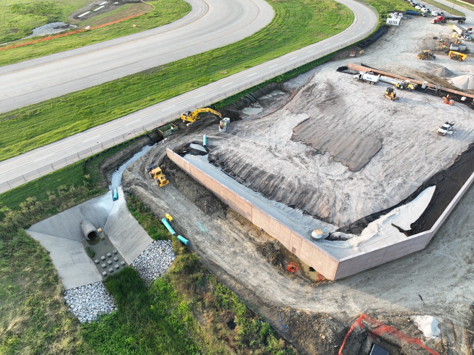 An aerial image of a vault building being constructed, with a culvert nearby.